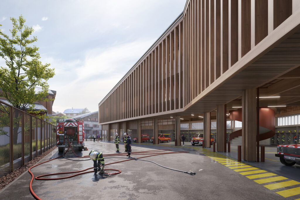 Perspective 3D du centre de secours de Megève, dessiné par NTSA Architectes, montrant l'utilisation de la cour de service en lien avec les remises des véhicules des pompiers, surmontées des étages de bureaux et de salle d'entrainement, filtrés par une massive seconde peau en bois foncé rappelant l'architecture traditionnelle de montagne.